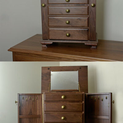 Jewelry armoire with lift up lid mirror and handing necklace doors