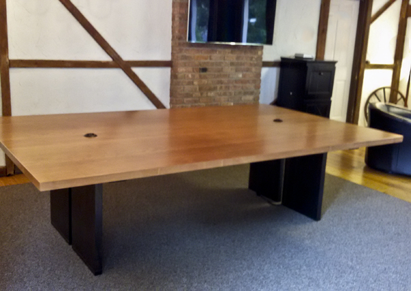 Square corner conference table with black panel legs